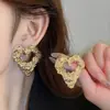 Pendientes de amor plisados y ahuecados transfronterizos europeos y americanos, pendientes de alta gama, pendientes de nicho de lujo ligeros, pendientes de moda exagerados para mujer