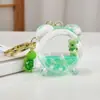 Muñeca de zorro verde linda en llavero de botella de aceite llavero de botella de arena movediza acrílica colgante para bolso regalo al por mayor