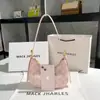 Comercio exterior al por mayor nicho bolsa rosa para axila mujer verano 2022 nueva moda Tongqin bolsa de hombro tipo baguette Creciente