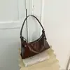Bolso de mano minimalista de nicho estilo coreano para mujer, nuevo de moda principios de otoño 2026, de alto valor, bandolera casual de color sólido