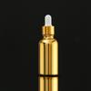 Botella de aceite esencial con galvanoplastia de oro, subbotella cosmética, botella de spray, botella de vidrio prensado, botella de loción crema a prueba de luz