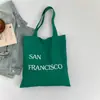 Bolsa de Lona com Estampa de Letras Nova Primavera Grande Capacidade Bolsa de Ombro Feminina Simples Fresca Versátil