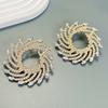 Pendientes de girasol con incrustaciones de cristal de aleación en espiral exagerada transfronteriza europea y americana, joyería femenina para la cena con temperamento al por mayor para mujer