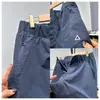 Pantalones casuales holgados cónicos funcionales de tres capas tipo softshell estilo americano con etiqueta blanca para hombres y mujeres, pantalones largos para hombres