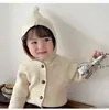 Cardigã de tricô com capuz e pompom estilo coreano para bebês, para meninos e meninas, suéter macio e estiloso com botões de abotoamento simples, peça de cima versátil