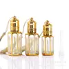 Frasco octogonal de óleo bronzeador 12ml Frasco de perfume do Oriente Médio Frasco com rolo aplicador para massagem nos olhos Vidro galvanizado frasco vazio