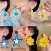 Aretes de isla hechos a mano de girasol de rafia y pasto, aretes de flores grandes exagerados de personalidad junto al mar, venta al por mayor de aretes