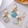 Novo chaveiro de pérola em forma de coração pingente ins fofo pequeno fresco cor quebrada pingente de bolsa para capa de fone de ouvido