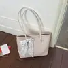 Bolsa de mano de lujo de alta gama para mujer, nuevo modelo de verano 2026, bolso de hombro con patrón tejido de nicho, bolso de mano de gran capacidad