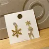 Pendientes asimétricos de ciervo con copo de nieve de venta caliente transfronteriza moda simple personalidad nicho lujo ligero pendientes de alta gama