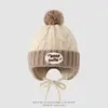 Chapéu infantil com proteção auricular em blocos de cor estilo coreano, chapéu quente de outono e inverno com pompom, chapéu de enfiar unissex