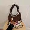 Tendencia transfronteriza bolsa simple de dumplings moda nicho para mujer bolso de hombro individual 2026 otoño nuevo bolso de mano elegante bolso cruzado
