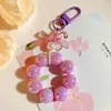 Llavero Colgante de Coche con Lazo de Perlas Electrochapado Color Caramelo Pintura para Hornear Hebilla Pequeña para Puerta Accesorios de Perla Bolsa