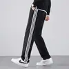 Conjunto deportivo de moda para primavera y otoño para hombres y mujeres, con diseño de tres rayas, ropa atlética casual, conjunto de running transfronterizo, cárdigan y pantalones largos, un conjunto de dos piezas
