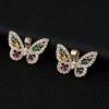 Versión coreana de pendientes colgantes de mariposa con circonita de color microincrustada pendientes cruzados de cobre chapado en oro de 14K accesorios de joyería venta al por mayor