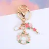Llavero Colgante de Conejo con Guirnalda Estilo Coreano Colgante Pequeño Fresco de Conejo Luna Flor de Cerezo Decoración de Bolsa de Pareja