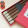 Nueva cabeza de calabaza sándalo rojo palillos moda nacional caja de regalo traje palillos madera redonda fu madera de ala de pollo caja de regalo hogar venta al por mayor
