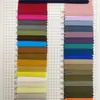 En stock, tela a cuadros blanca de nailon-poliéster de 0,25 denier, suave y amigable con la piel, tela a cuadros teñida de nailon clásica y moderna para pantalones