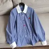 2026 Nueva Camisa de Rayas Color Block con Dobladillo Asimétrico, Camisa Cárdigan Estilo Boyfriend Top al por Mayor H12CT23302