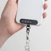 Nueva almohadilla para cordón de teléfono universal con conector metálico fijo montado en la parte posterior, soporte para tarjeta de teléfono cruzado con clip de 360 grados