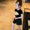 Conjunto de Verano Nuevo para Niñas 2026, Estilo Popular de Alta Venta de Este Año, Top Negro de Manga Corta con Dibujos y Shorts Delgados para Niñas