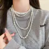 Colección Larga de Collares Superpuestos de Perlas Swarovski para Mujer, Estilo Lujo Ligero, Cadena Versátil para Suéter con un Toque de Alta Gama, Venta al por Mayor Otoño e Invierno