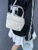 Bolso Pequeño Casual Ins para Mujer 2026 Nuevo Estilo Coreano Bolso Cubo de Lona Diseño de Nicho Bolso de Hombro Único Cruzado