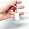 Llavero con forma de cachorro tridimensional de dibujos animados, con flocado de resina, para coche, bolso, venta al por mayor