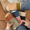 Calcetines de lana otoño e invierno nuevos calcetines de media pantorrilla lujo moderno bordado rayas versátil casual punto de fábrica al por mayor versátil