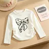 Nueva colección de primavera y otoño: Camisetas básicas lindas de manga larga y cuello redondo para niñas, con adorables estampados de moños, disponibles al por mayor