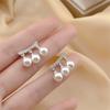 Pendientes elegantes de lujo con forma de lazo y perlas, con un diseño de nicho exquisito y personalidad sencilla, pendientes de otoño e invierno de gran sentido.