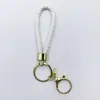 Venta al por mayor del fabricante Llavero de Cuerda de Aleación Tejida y Cuero Accesorios Colgantes Material PU Bolsas Pequeñas de Regalo Accesorios para Llaveros