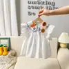 Nuevos Tops de Manga Corta para Niñas Verano 2025 Estilo Coreano Falda de Princesa Literaria Camisa de Muñeca para Niños Camisa Bordada de Color Puro