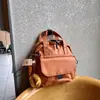 Mochila pequeña ligera y linda, versión de cuero impermeable, bolso de mano pequeño, mochila de moda impermeable versátil