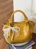 Bolso pequeño simple y elegante para mujer, nuevo bolso tipo cubo verano 2026, bolso cruzado de color sólido texturizado de moda para mujer
