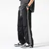 Pantalones de paracaidista para hombre primavera y otoño 2024 Nuevos pantalones rectos holgados marca de moda de trabajo a rayas casuales para hombre