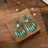 Pendientes largos negros de estilo étnico retro europeo y americano, pendientes de borlas de flores pequeñas de Yunnan, joyería popular exagerada al por mayor