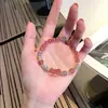 Suministro de fábrica pulsera de cristal de fresa natural para mujer cuerda de mano año de nacimiento tejida regalo para novias estilo coreano estilo ins