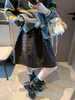 Academia Moqie Atmósfera Estilo Coreano Retro Cuadros Elástico Cintura Alta Voluminoso Botón Falda Línea A MQ2174