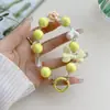 Cadena para teléfono móvil con cuentas, color caramelo fresco y chapado en color, con lazo de amor y pequeñas flores, colgante para funda de teléfono para mujer.