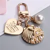 Llavero de Concha con Forma de Corazón Lindo Regalo Pequeño Creativo Estilo Ins Joyería de Metal Colgante de Perla Encanto para AirPods