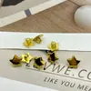 Plástico galvanizado estrella de plástico botón de plástico estrella dorada de cinco puntas botón 15MM camisa camisa DIY
