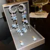 Pendientes de borla de flor de concha blanca transfronterizos europeos y americanos con perlas, pendientes de estilo de corte francés, pendientes ligeros y lujosos con un toque de alta gama