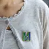 Broche de aço inoxidável com gota de óleo de cor nova transfronteiriço com 26 iniciais, nome no peito, iniciais, joia de personalidade feminina