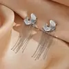Pendientes de botón con borla de metal simples transfronterizos europeos y americanos, pendientes de diseño de nicho versátiles de personalidad, adornos para orejas de lujo ligero y de alta gama para mujer