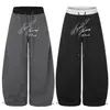 Moda 2026 nueva colección: Pantalones casuales de pierna ancha y pierna curva, de color liso, con estampado de letras, juveniles y a la moda, venta al por mayor desde una sola fuente, 55