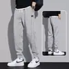 Pantalones deportivos cálidos con forro de felpa de marca de moda otoño e invierno 2026 para hombre, pantalones jogger holgados de color liso con cordón, pantalones largos para primavera