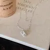 Collar con colgante de mini bolso para mujer, cadena de suéter de diseño de nicho de lujo ligero de alta gama, accesorios de cadena de suéter nuevos para otoño e invierno
