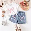 26 looks de verão para meninas europeias e americanas: nova camiseta estilo preppy com gravata borboleta + shorts jeans retrô, versátil e estiloso, atacado