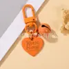 Estilo Casual y Lindo Llavero Colgante de Campana con Corazón Pintado Colorido Funda para Teléfono Móvil Bolso Auriculares Set de Accesorios Pequeños